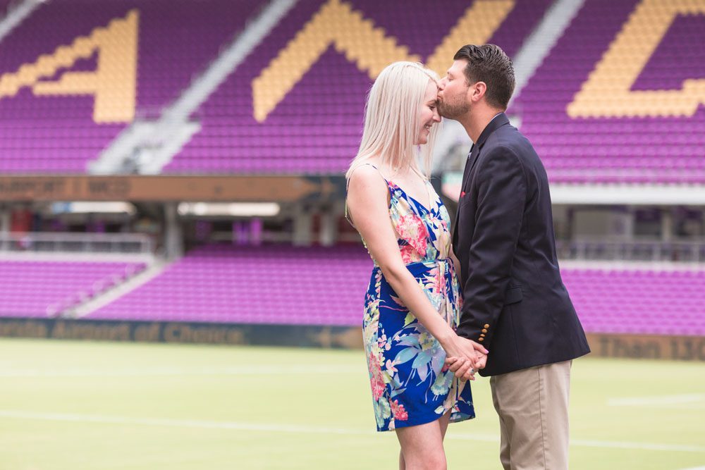 Orlando engagement photographer captures a surprise proposal on the field at the Orlando City Soccer Exploria stadium in downtown