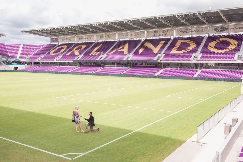 Orlando engagement photographer captures a surprise proposal on the field at the Orlando City Soccer Exploria stadium in downtown